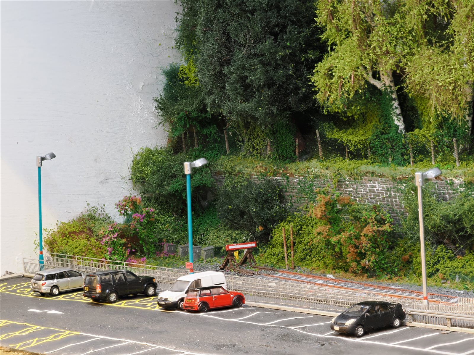 Buffer stops, retaining wall and parked cars at the terminus end of Maesteg
