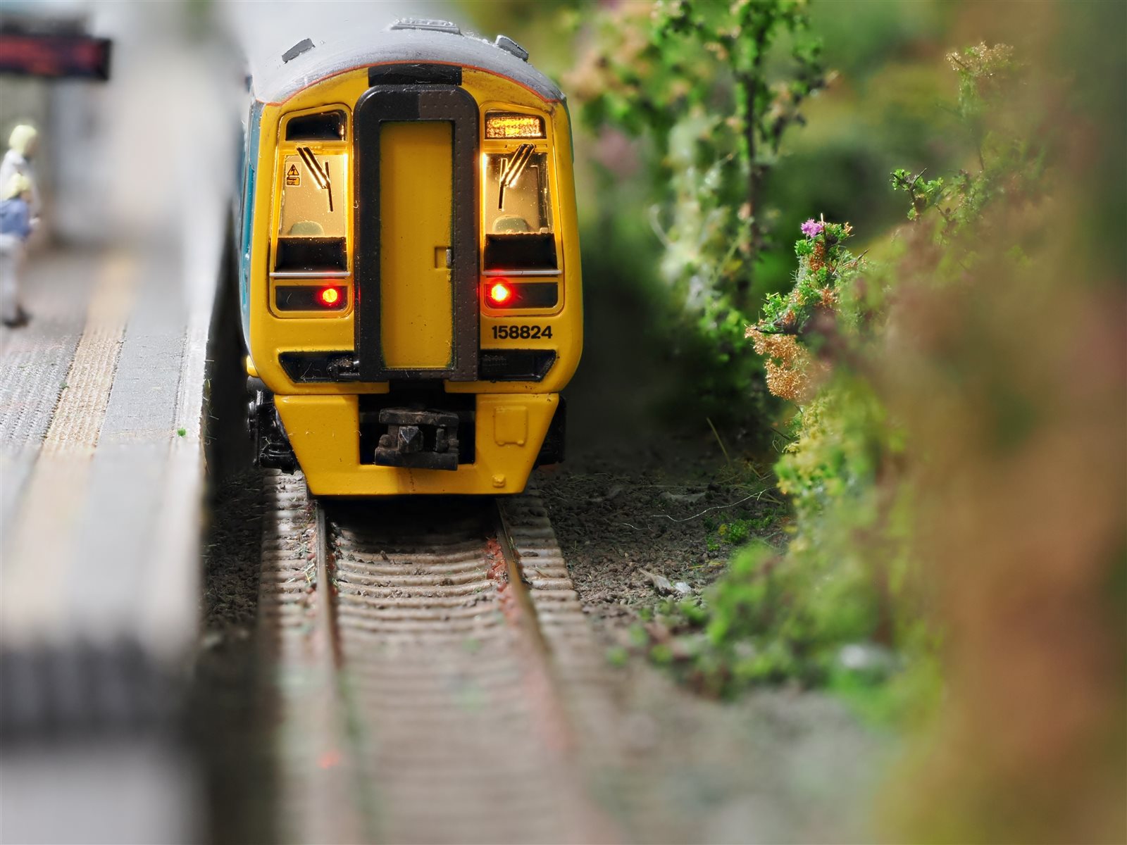 Track-level view of Class 158 158824 at Maesteg platform with tail lights