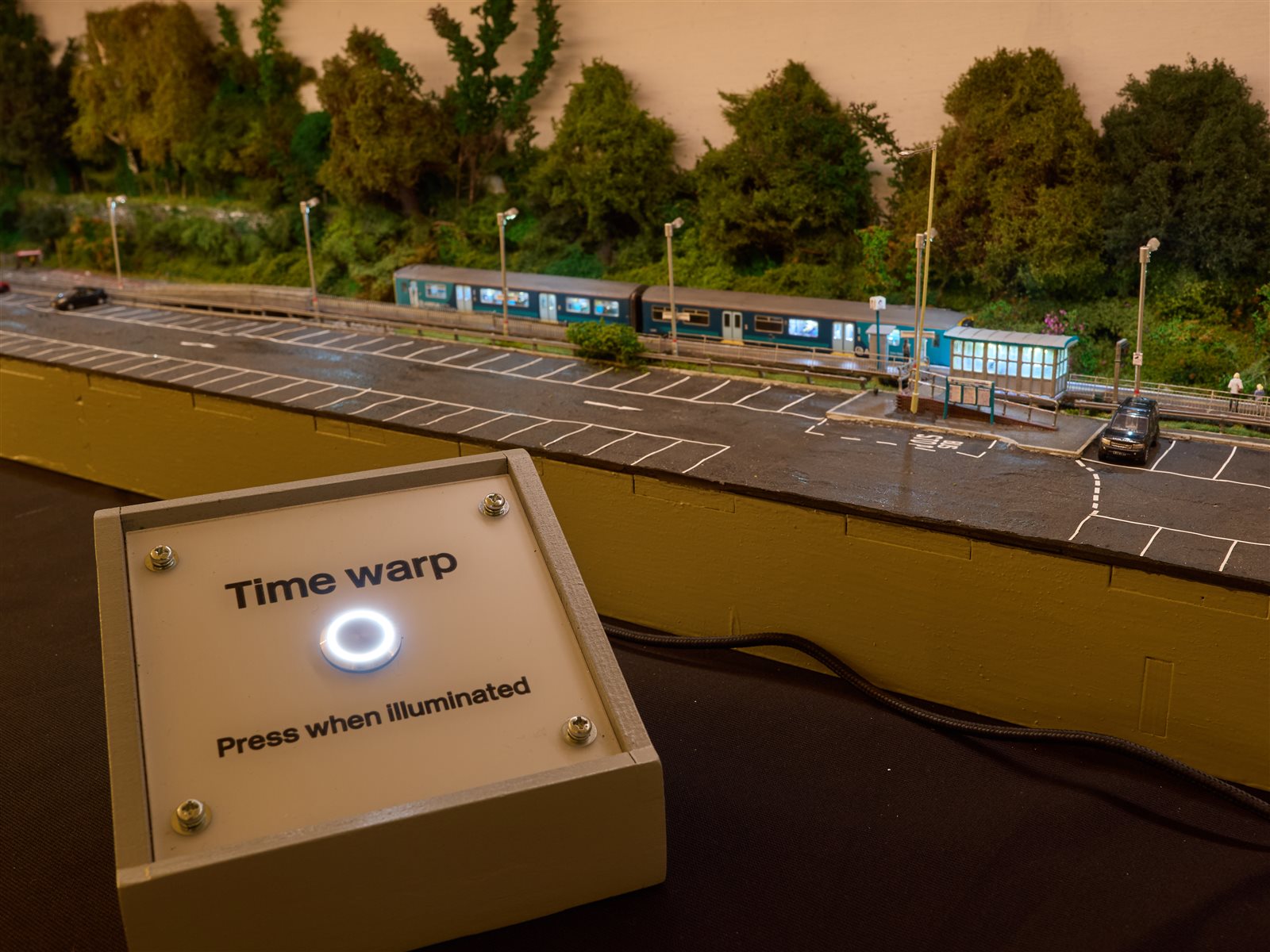 Full proscenium case at dusk with illuminated Time Warp button