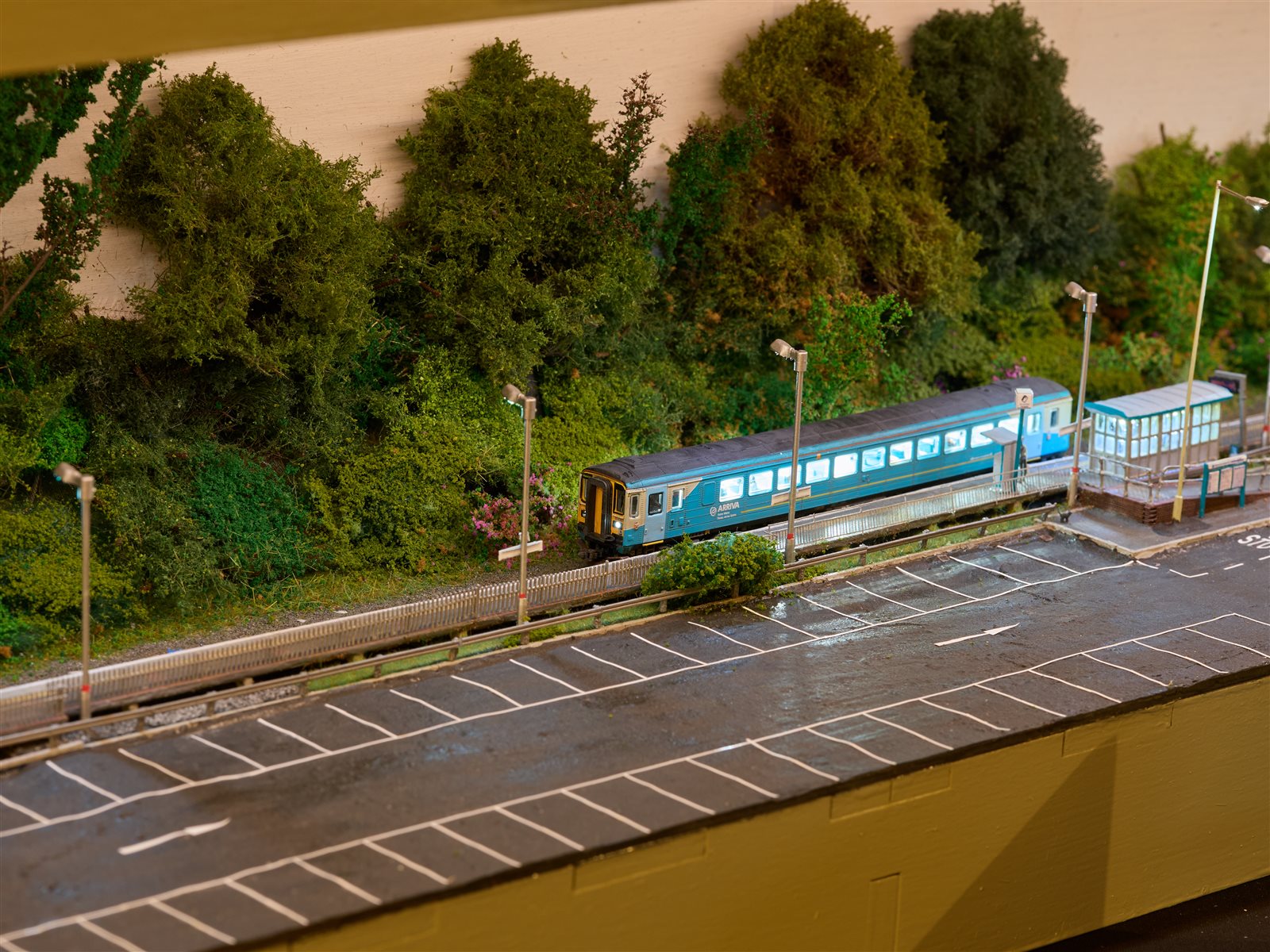 Platform lamps and illuminated DMU at dusk