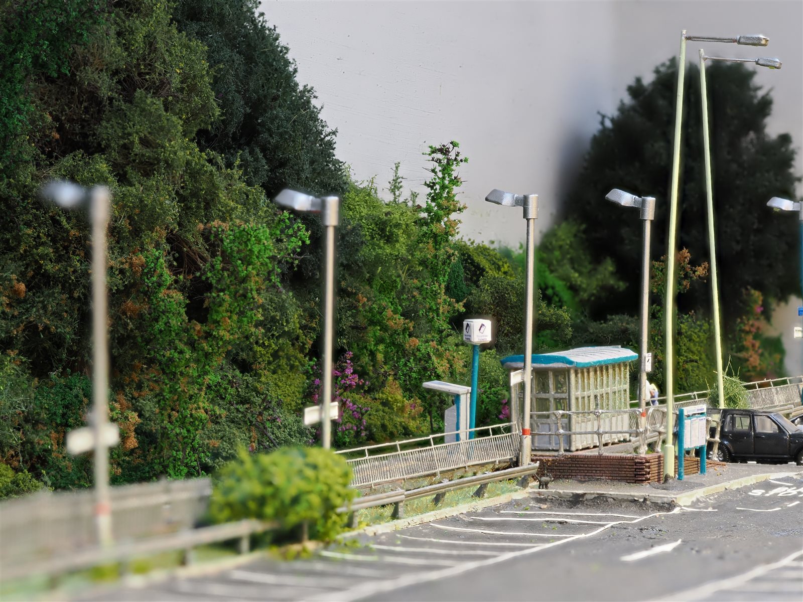 Perspective along the line of platform streetlamps and trees
