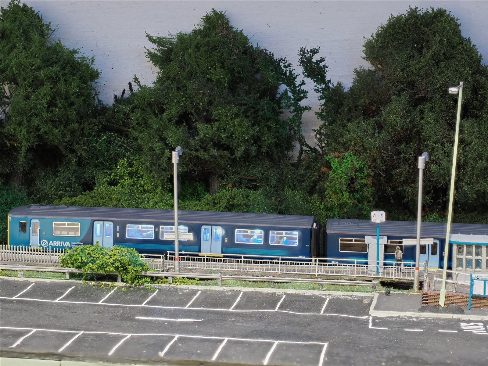 Wide dusk view of an illuminated train at the platform