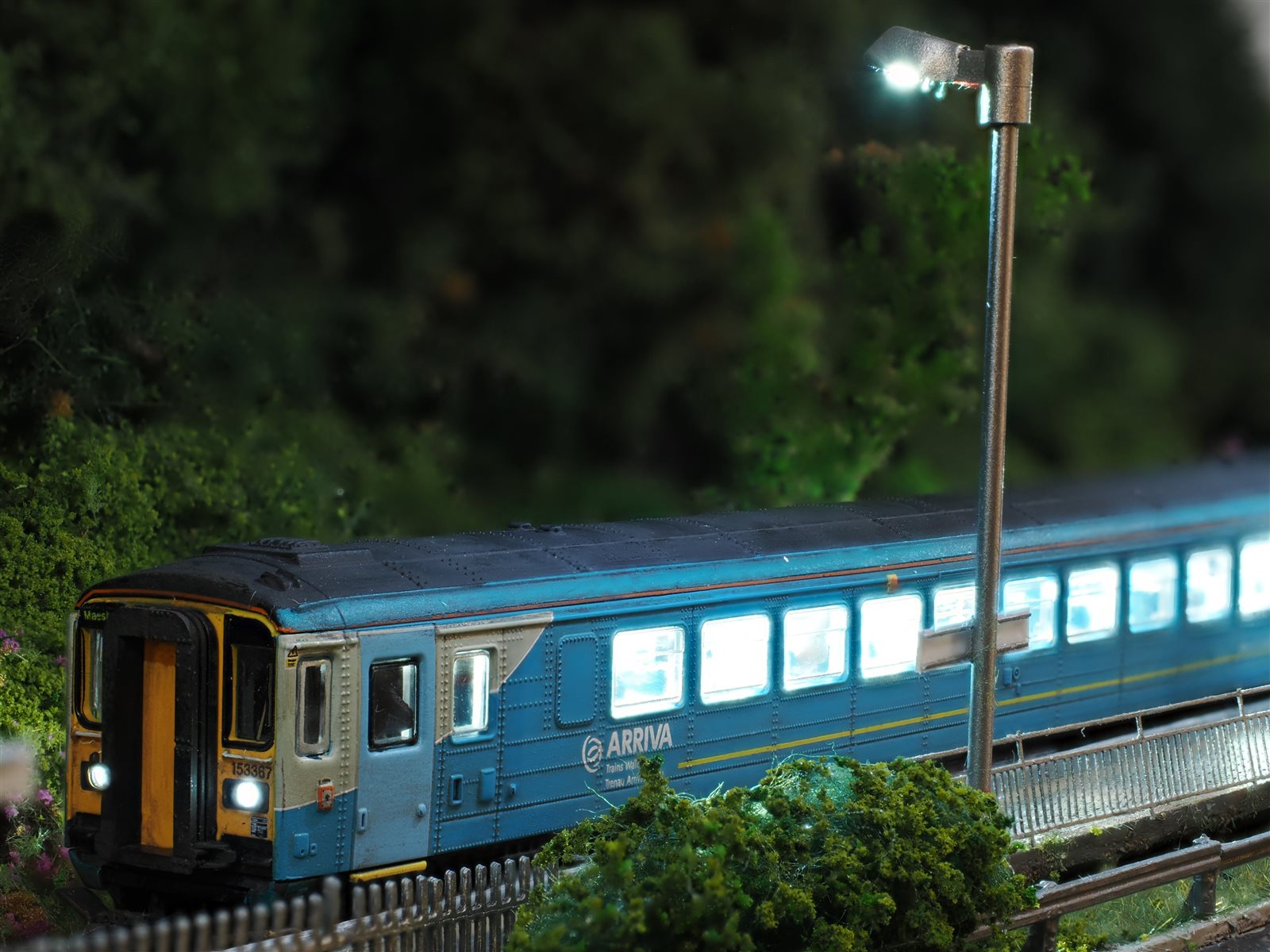 Arriva Trains Wales Class 153 at night under working platform streetlamp